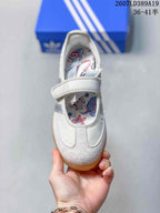 Top view showing the rounded toe, hook-and-loop strap, and floral printed insole.
