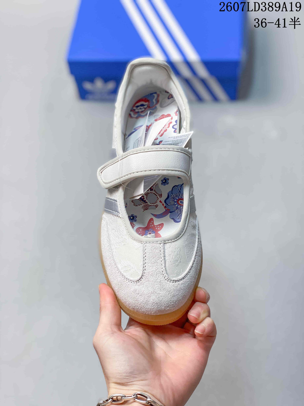 Top view showing the rounded toe, hook-and-loop strap, and floral printed insole.