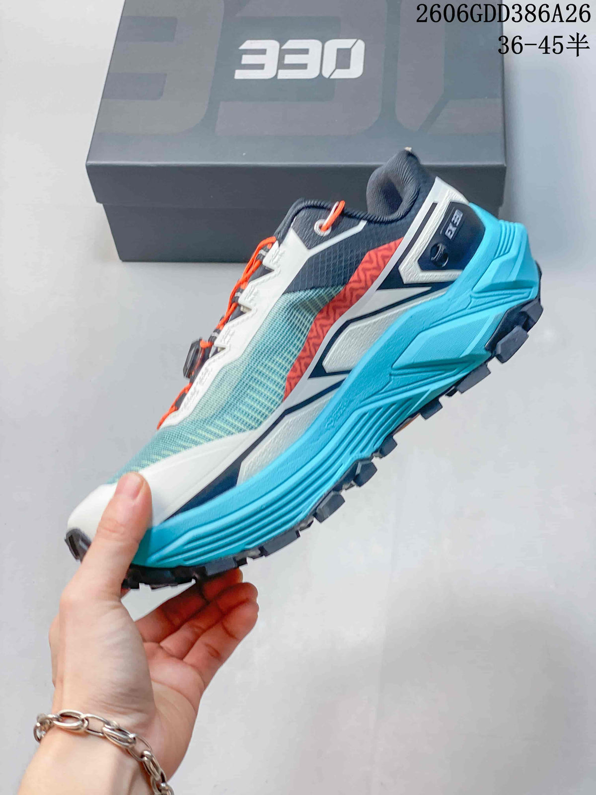 Side view of the Kailas FUGA EX330 trail shoe with turquoise midsole and orange detailing