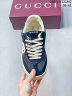 Front view of the navy sneakers with white laces