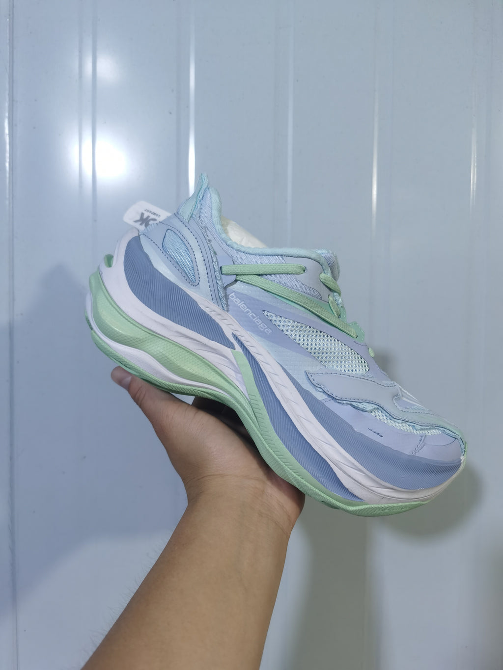 Side view of pale blue and green Balenciaga 9191 sneakers showing layered panels, mesh sections, and a sculpted sole.