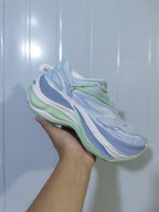 Side view of pale blue and green Balenciaga 9191 sneakers showing layered panels, mesh sections, and a sculpted sole.