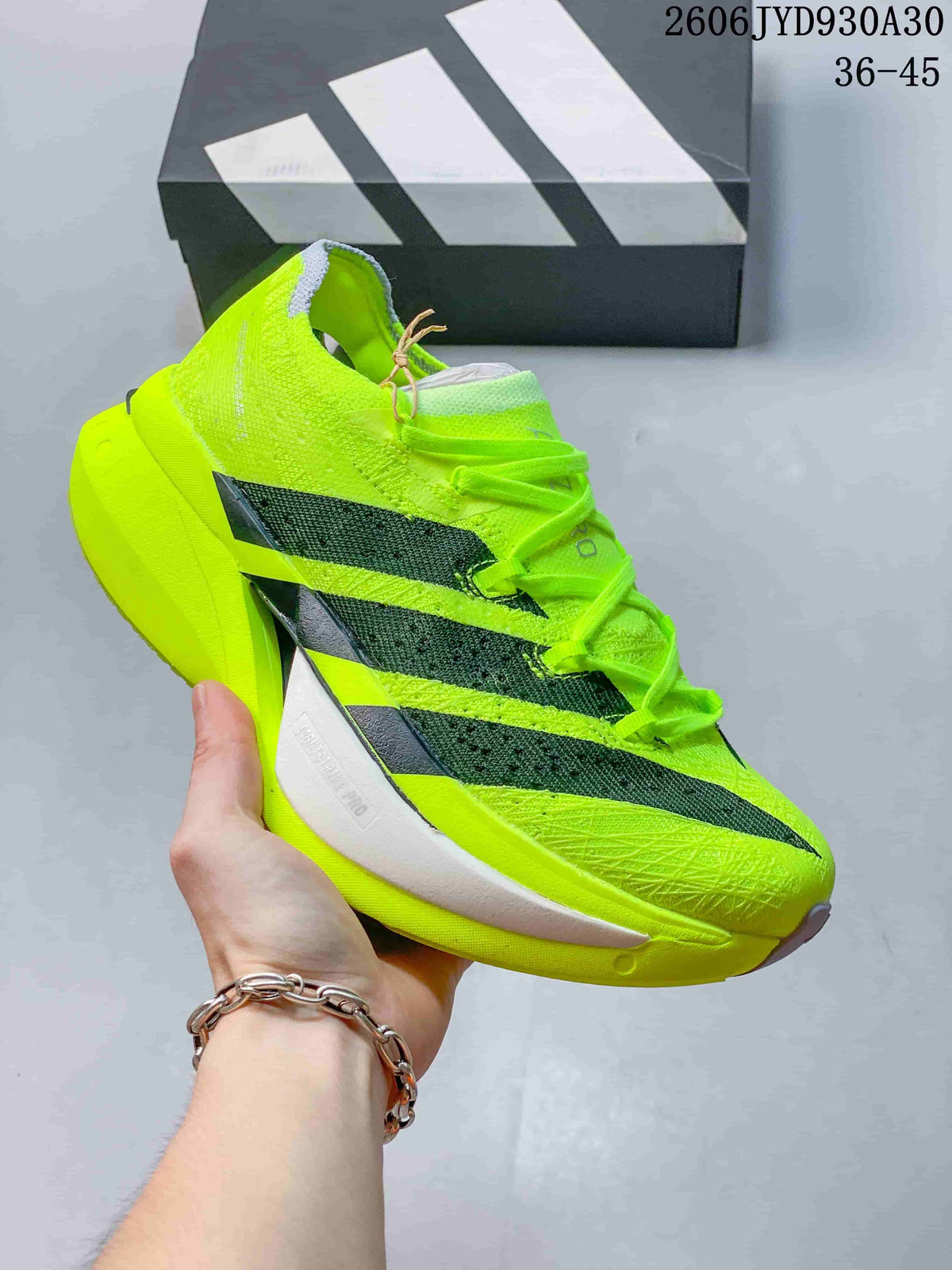 Neon yellow adidas Adizero Prime X3 shoe with dark side stripes.