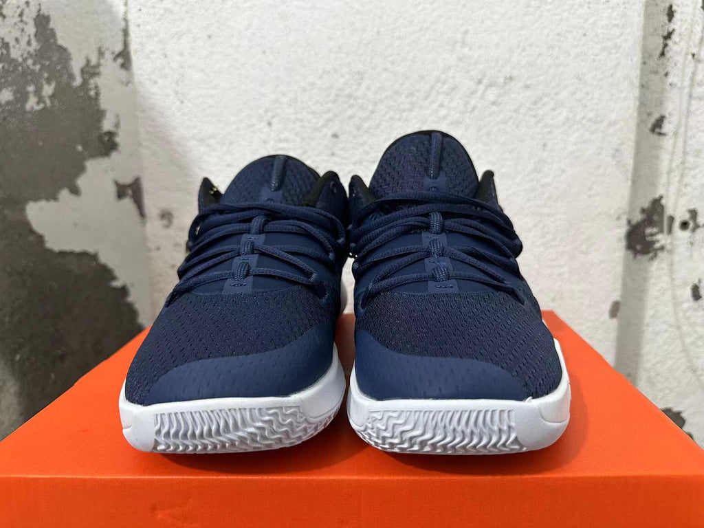 Front view showing navy blue uppers, laces, and white outsoles