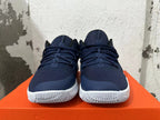 Front view showing navy blue uppers, laces, and white outsoles
