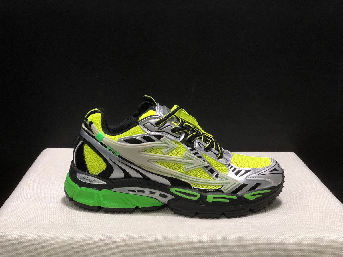 Lateral close view of one sneaker showing the layered side panels, neon green upper, and black textured outsole.