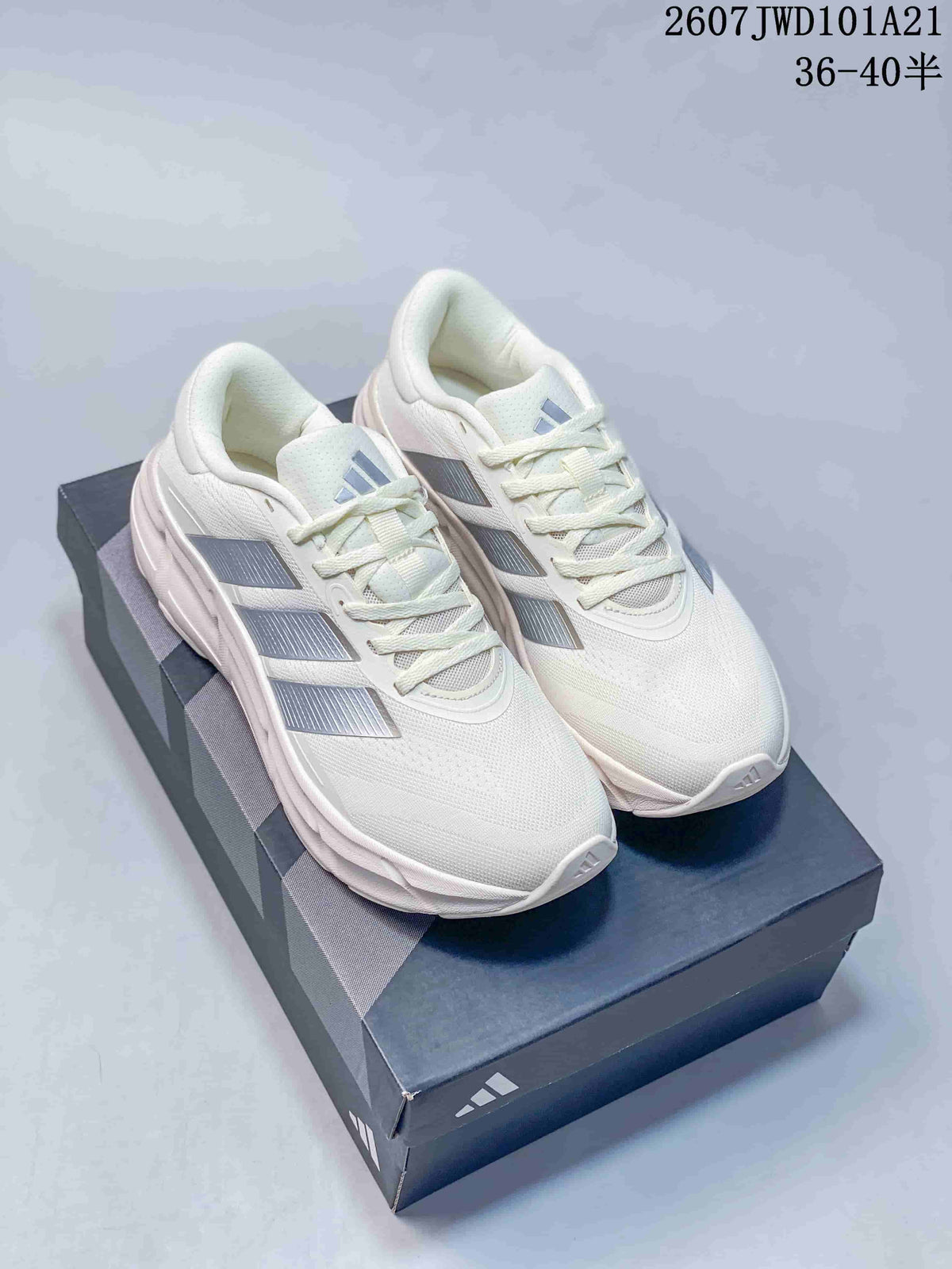 Pair of white Adidas low-top sneakers with silver side stripes displayed on a shoebox; overlay text shows style code 2607JWD101A21 and sizes 36–40.5.