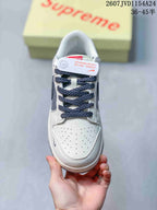 Top view showing the perforated white toe box, dark patterned laces and tongue branding.