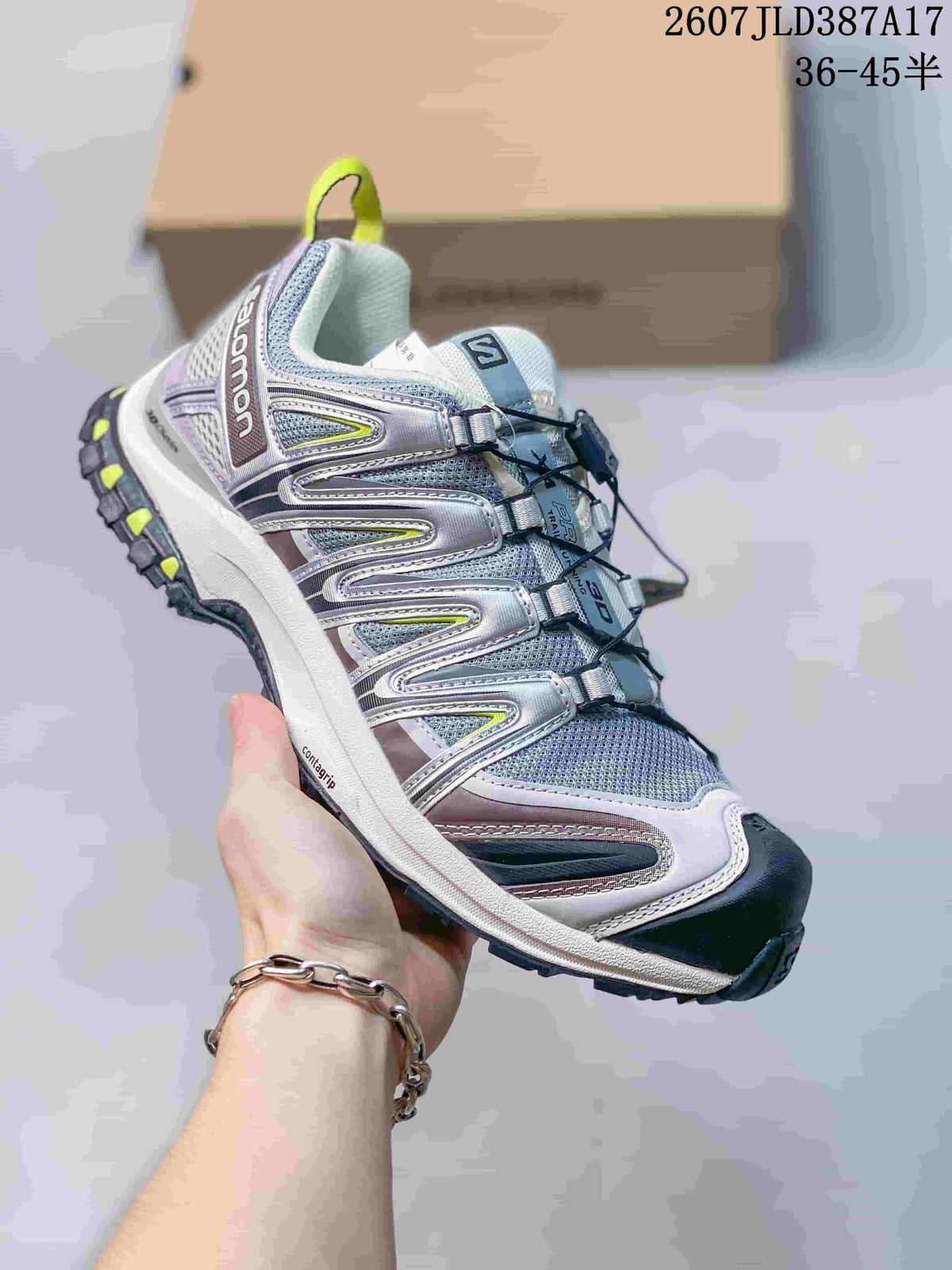 Side view of the silver and white Salomon XA PRO 3D sneaker showing the reinforced upper, quick-lacing system and lugged outsole.