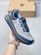 Angled side view of a gray and black DESCENTE SHIELD sneaker showing the BOA-marked closure, padded collar, and layered sole.