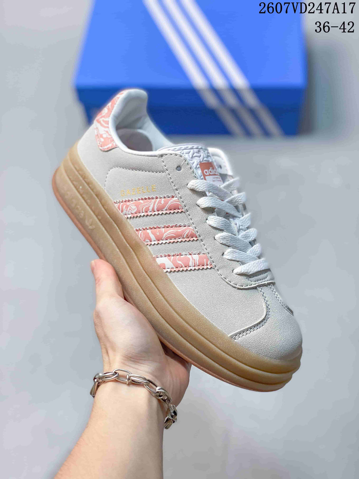 Angled side view showing Gazelle branding, pink patterned stripes, and the gum-colored platform sole.