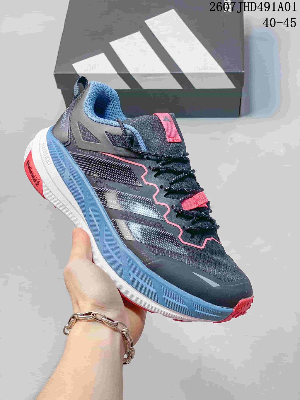 Dark gray Adidas Terrex low-top shoe with blue and pink accents; image displays the size range 40–45.