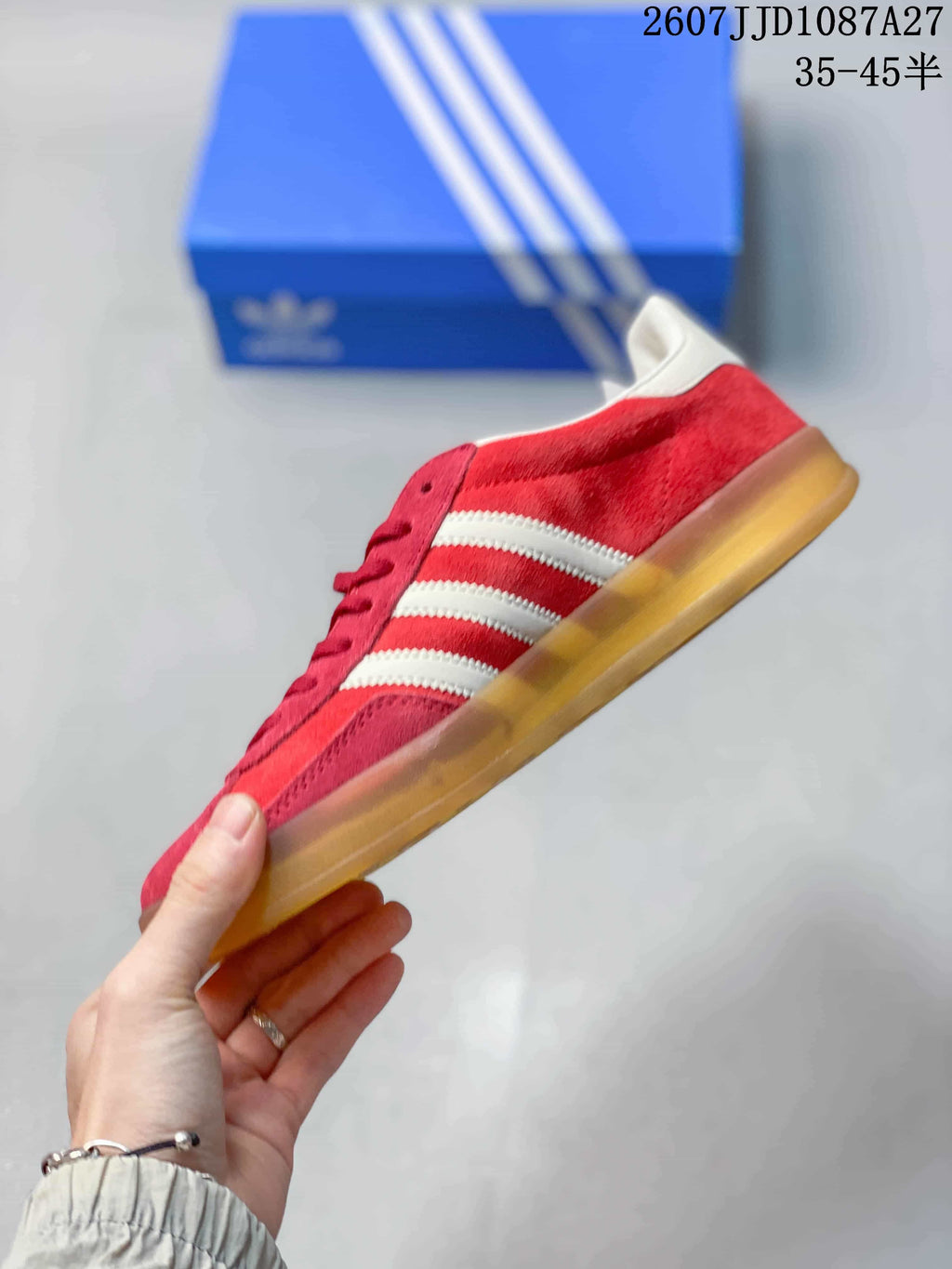 Side profile showing the red upper, white side stripes and low gum-colored sole.
