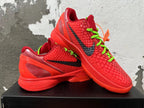 Pair of red Nike Kobe shoes showing black Swooshes, green laces, and heel details