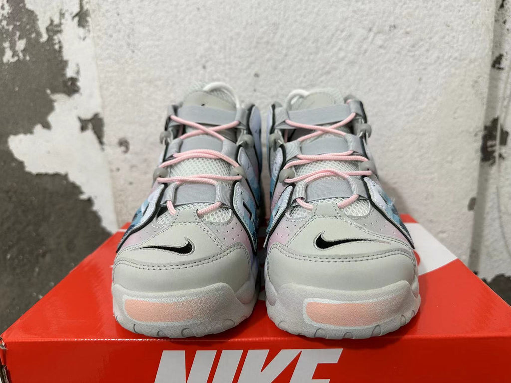 Front view of gray Nike Air More Uptempo sneakers with pink laces and pink sole accents