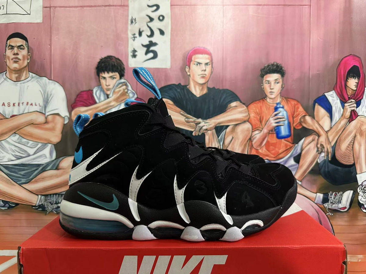 Black Nike high-top basketball shoes with white side details, blue accents, and visible cushioning, shown from the side.