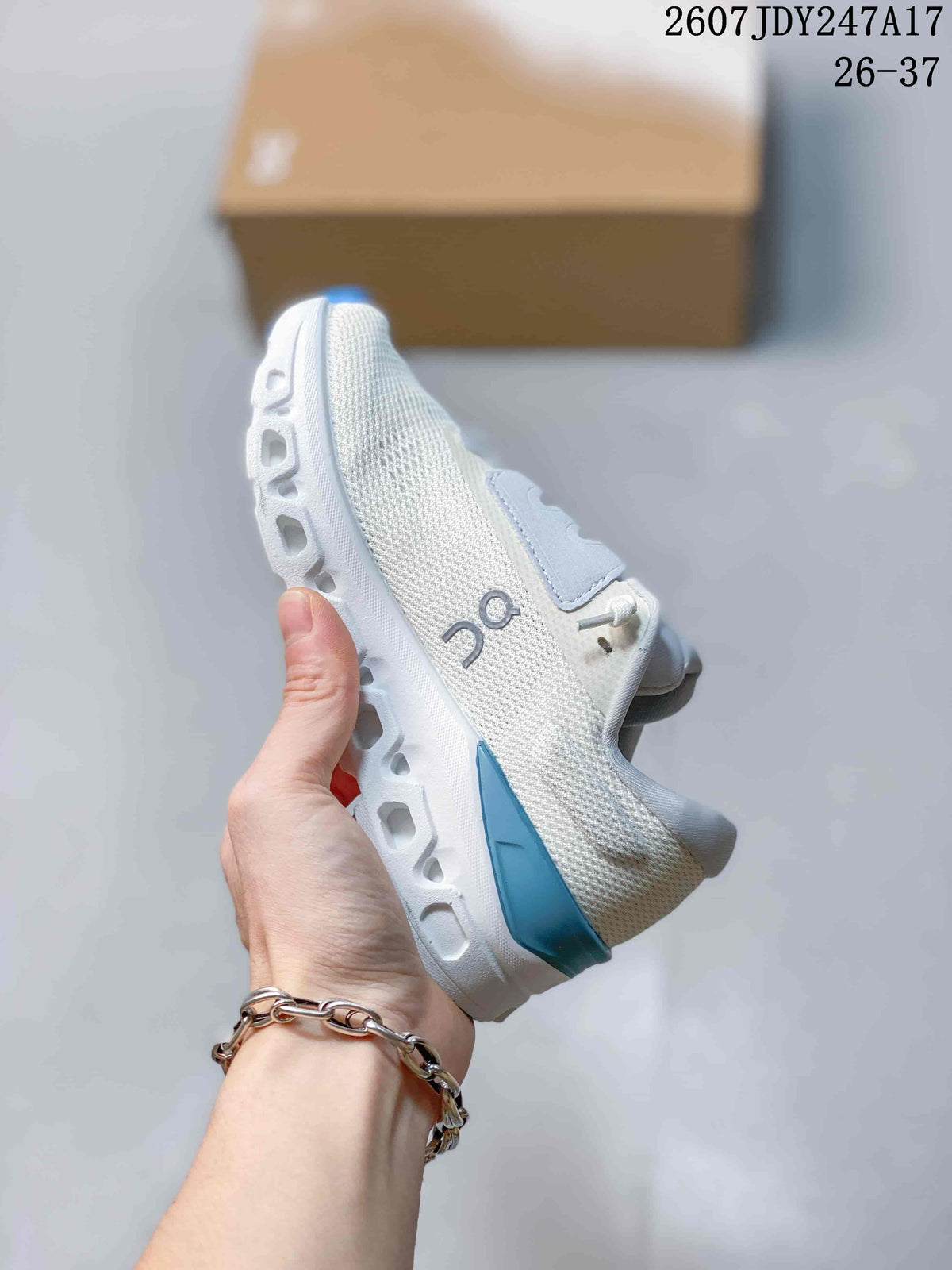 Side view highlighting the textured upper, lace panels, blue heel accent, and segmented midsole.