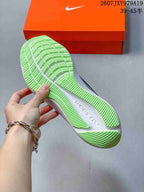 Close view of the bright green textured outsole and white midsole of the running sneaker; overlay shows style code 2607JXY979A19 and size range 39–45.