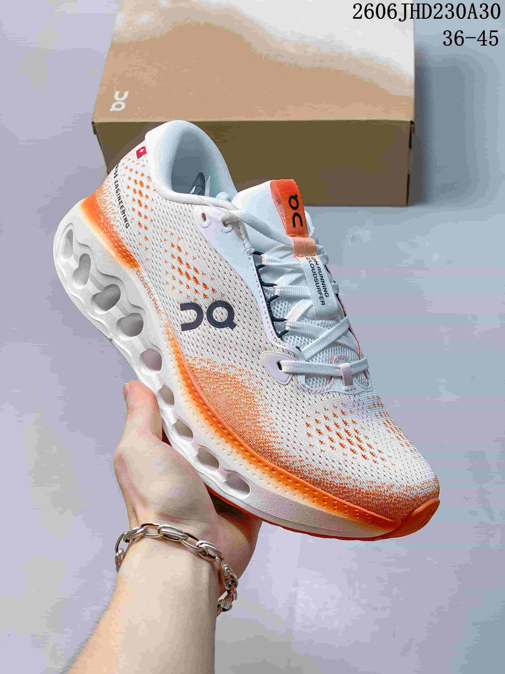 Angled side view of a white and orange On Cloudtilt sneaker