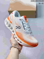 Angled side view of a white and orange On Cloudtilt sneaker