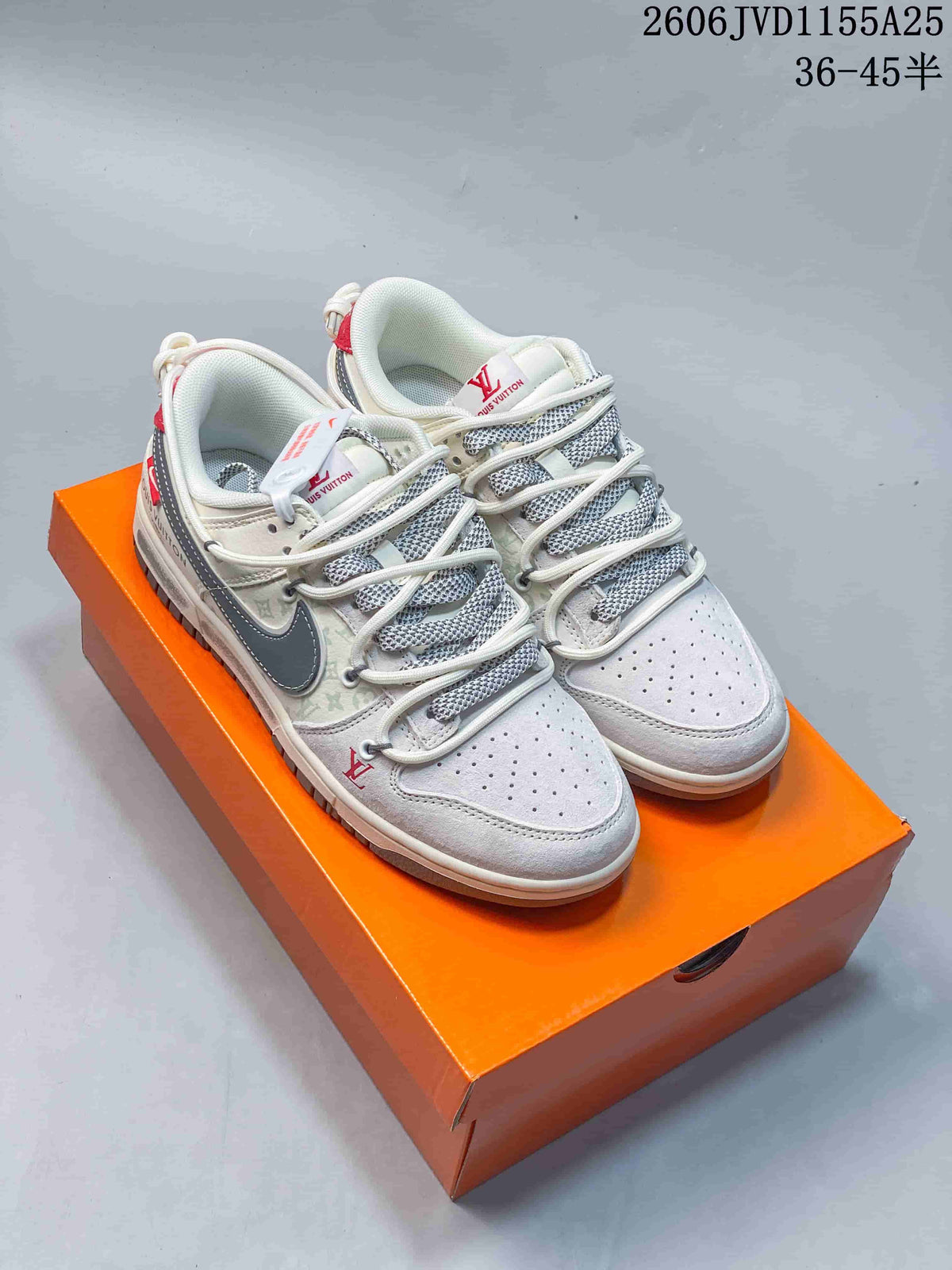 Cream and gray low-top sneakers with layered lace details on an orange box