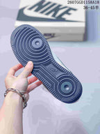 Close-up of the navy textured rubber outsole showing concentric circular traction patterns.