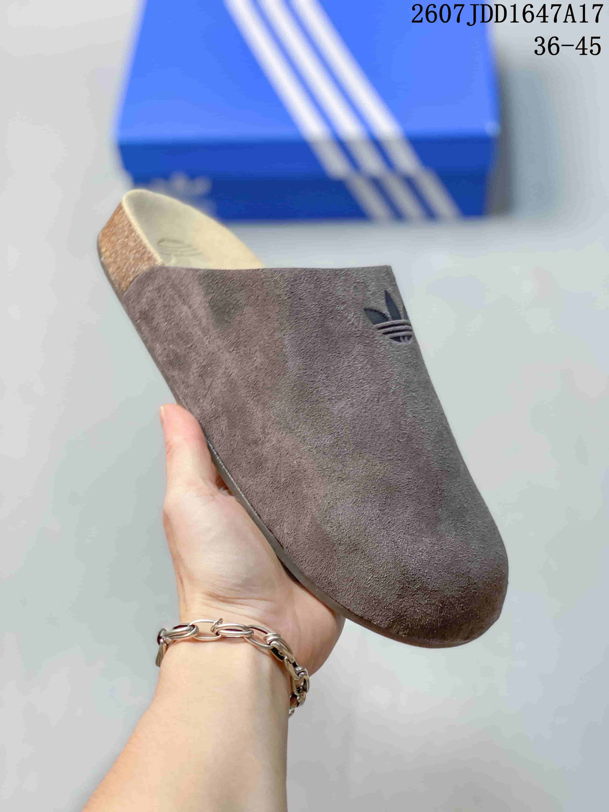 Close-up side view of a brown adidas Adimule mule slide showing the rounded toe and raised heel section.