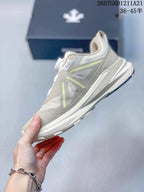 Side view of the beige low-top sneaker showing layered panels, light accent details, and a raised midsole.