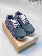 Pair of charcoal On Cloudmonster 3 running shoes with pink accents, shown from above.