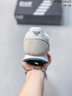 Rear view of the sneaker showing the light beige heel panel, white collar, and EA7 heel logo.