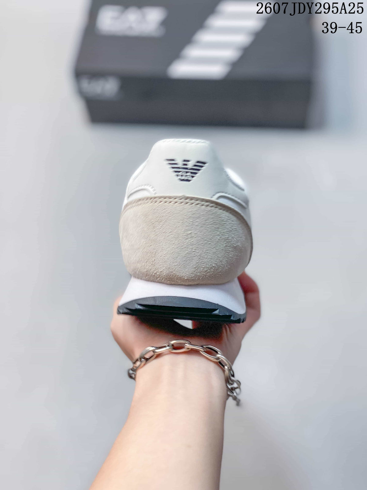 Rear view of the sneaker showing the light beige heel panel, white collar, and EA7 heel logo.