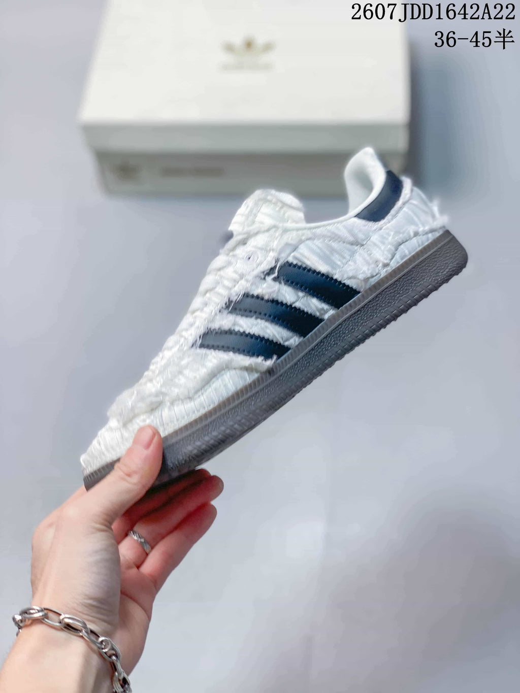 Side view showing the gathered white upper, navy stripes, and low-top silhouette.