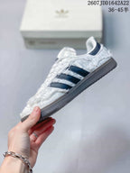 Side view showing the gathered white upper, navy stripes, and low-top silhouette.