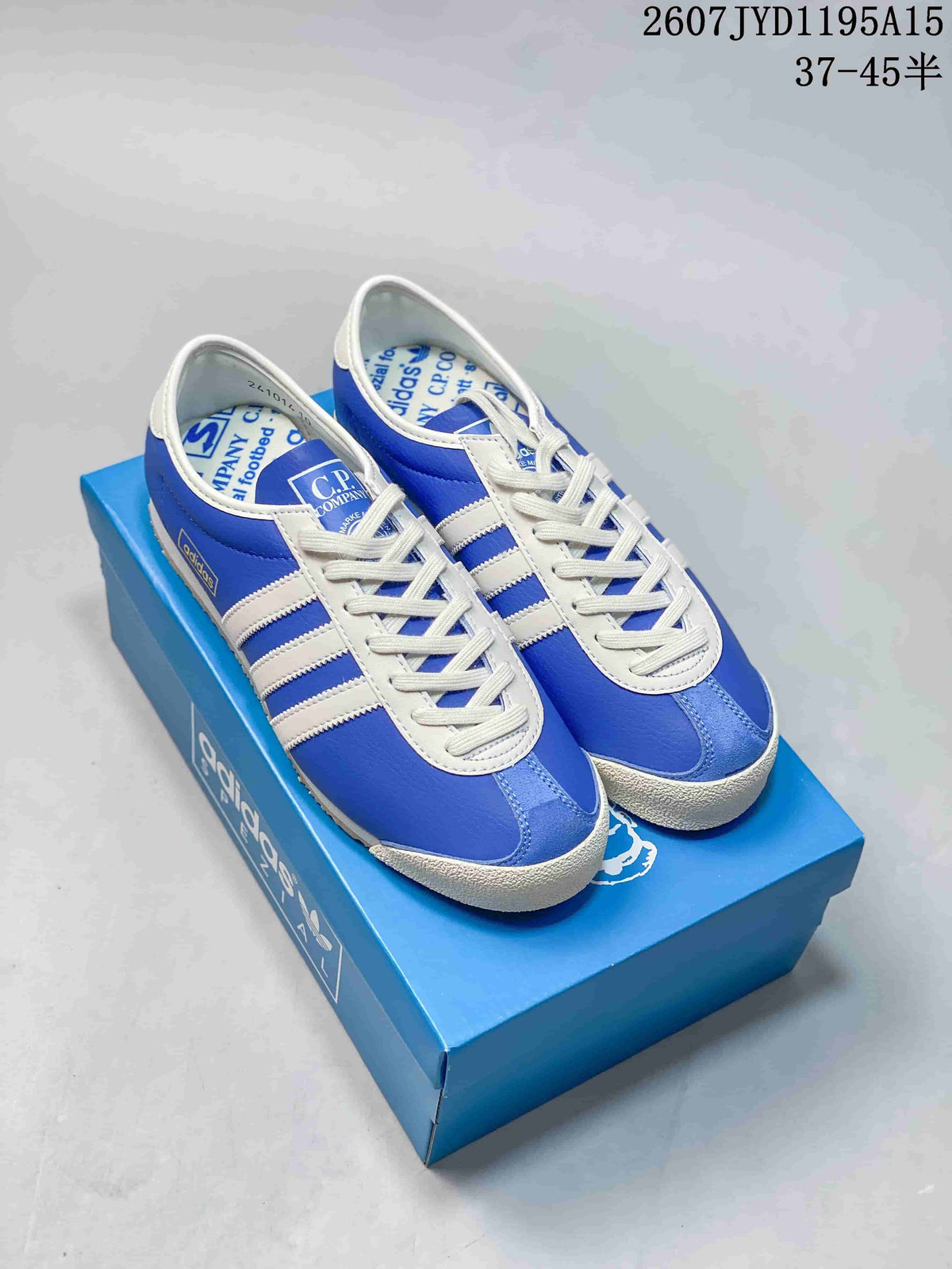 Blue and white adidas C.P. Company Italia SPZL sneakers displayed on a blue shoebox.