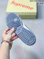 Close view of the gray rubber outsole showing circular and grid traction patterns with Nike branding.