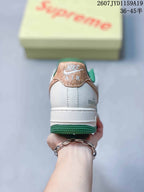 Rear view showing the white heel, tan heel tab, green outsole and visible Air branding.