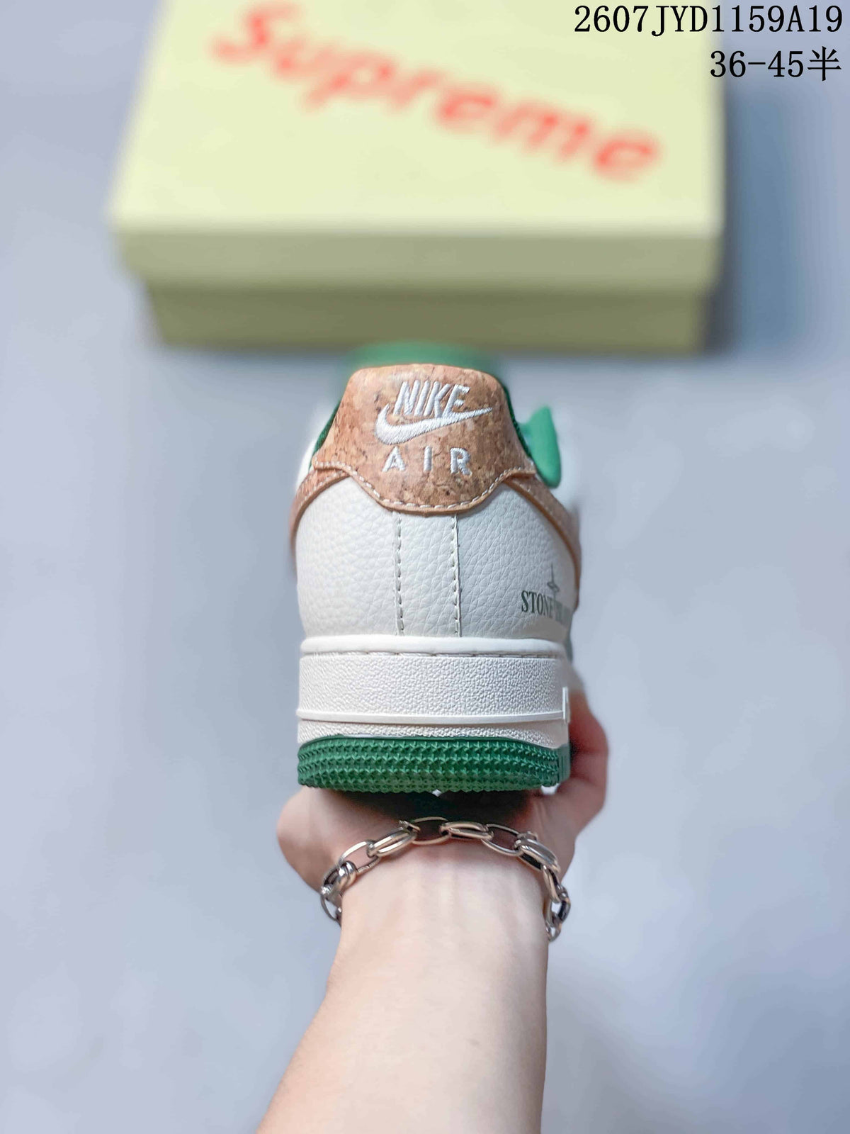 Rear view showing the white heel, tan heel tab, green outsole and visible Air branding.