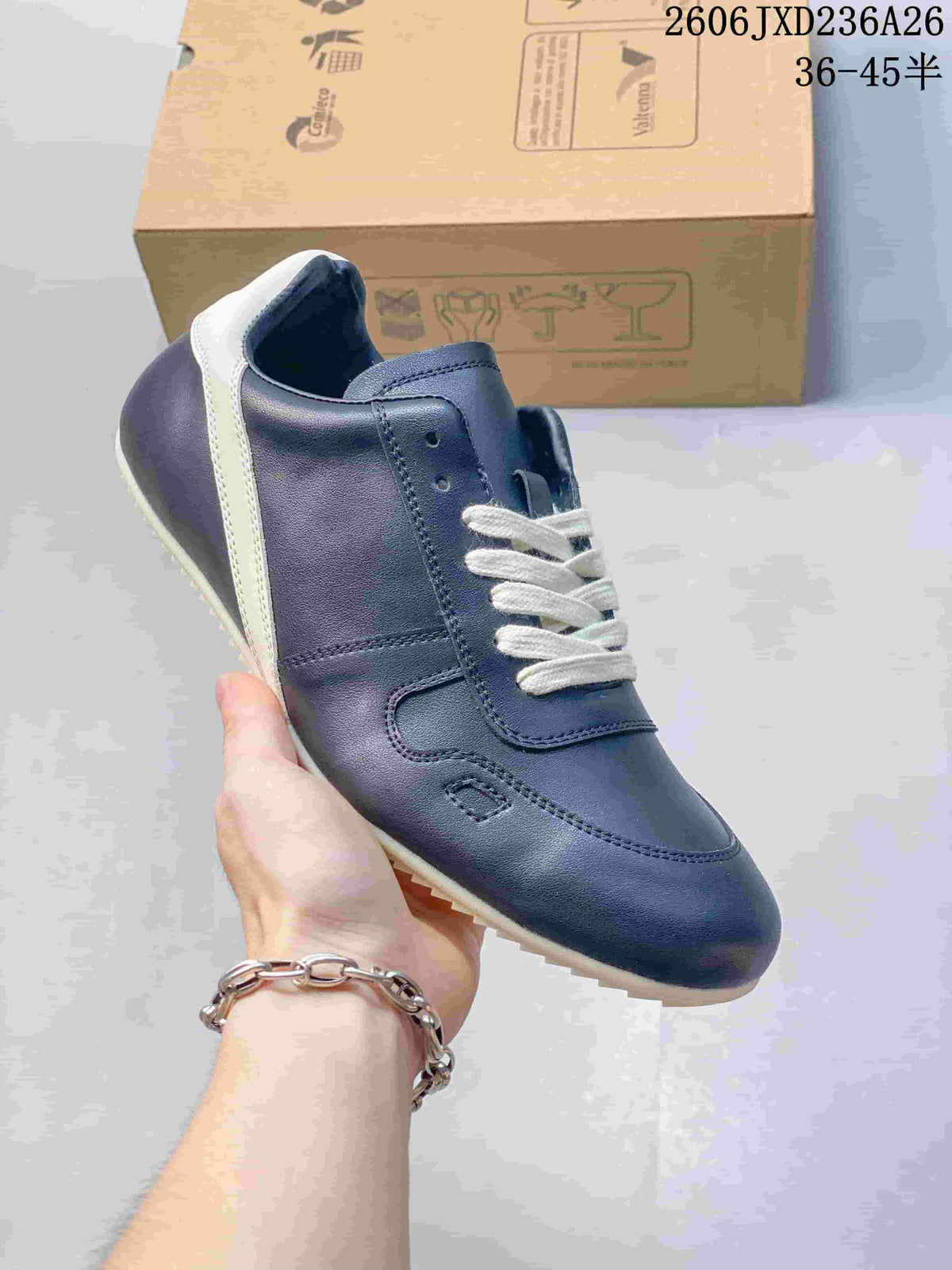 Close-up of a navy low-top sneaker with white laces and a contrasting heel strip.