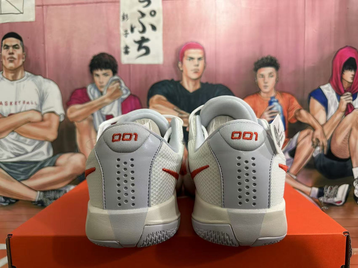 Rear view of white Nike GT Cut 3 basketball shoes with red accents and grey heel panels.