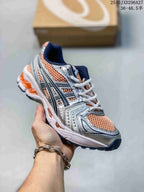 Silver sneaker with peach-orange mesh panels and white laces