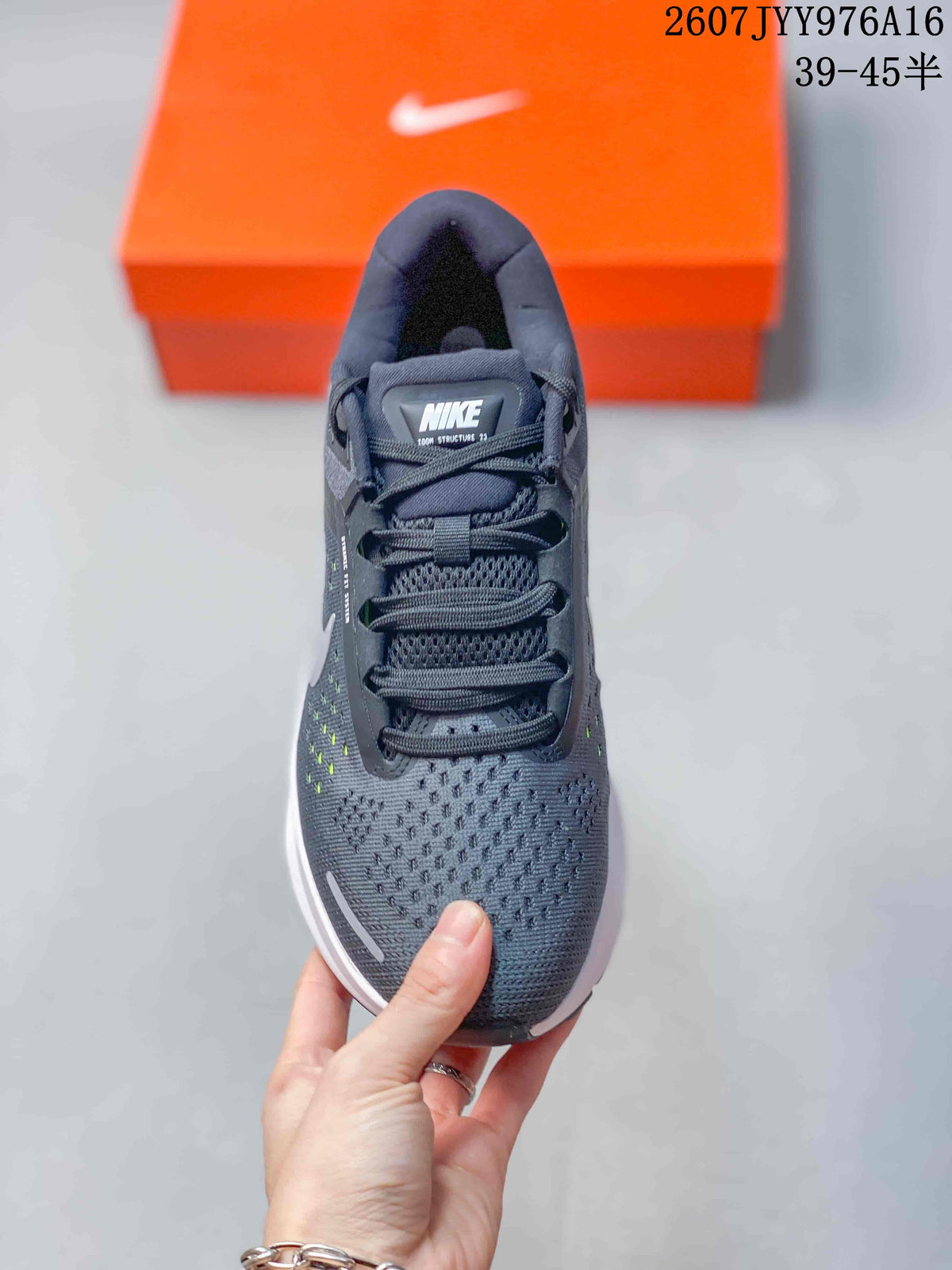 Top-down view of the gray lace-up sneaker showing the padded tongue, laces, mesh-textured toe box, and side detailing.