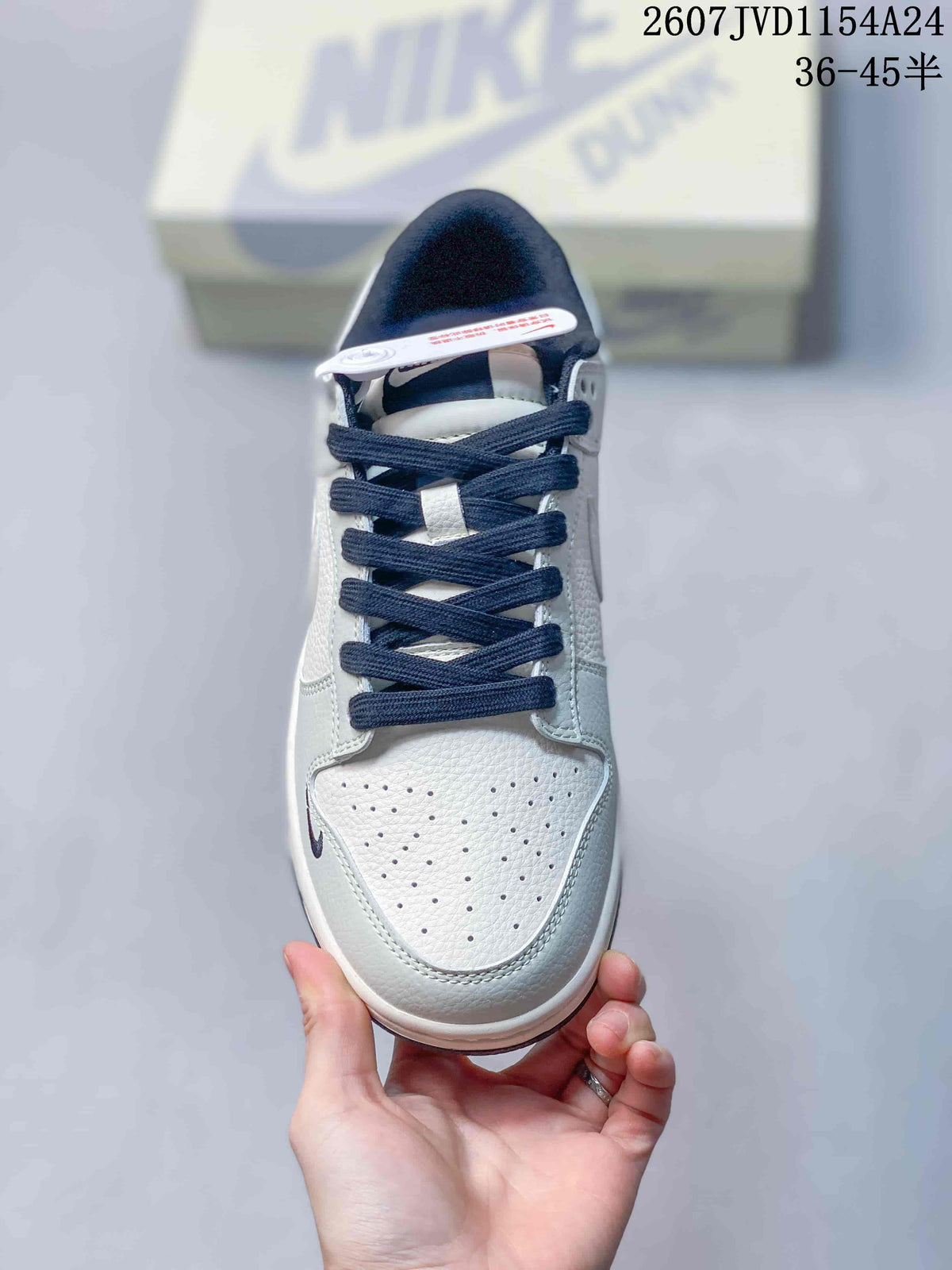 Top view of the sneaker showing the perforated white toe box, navy laces and dark padded collar.