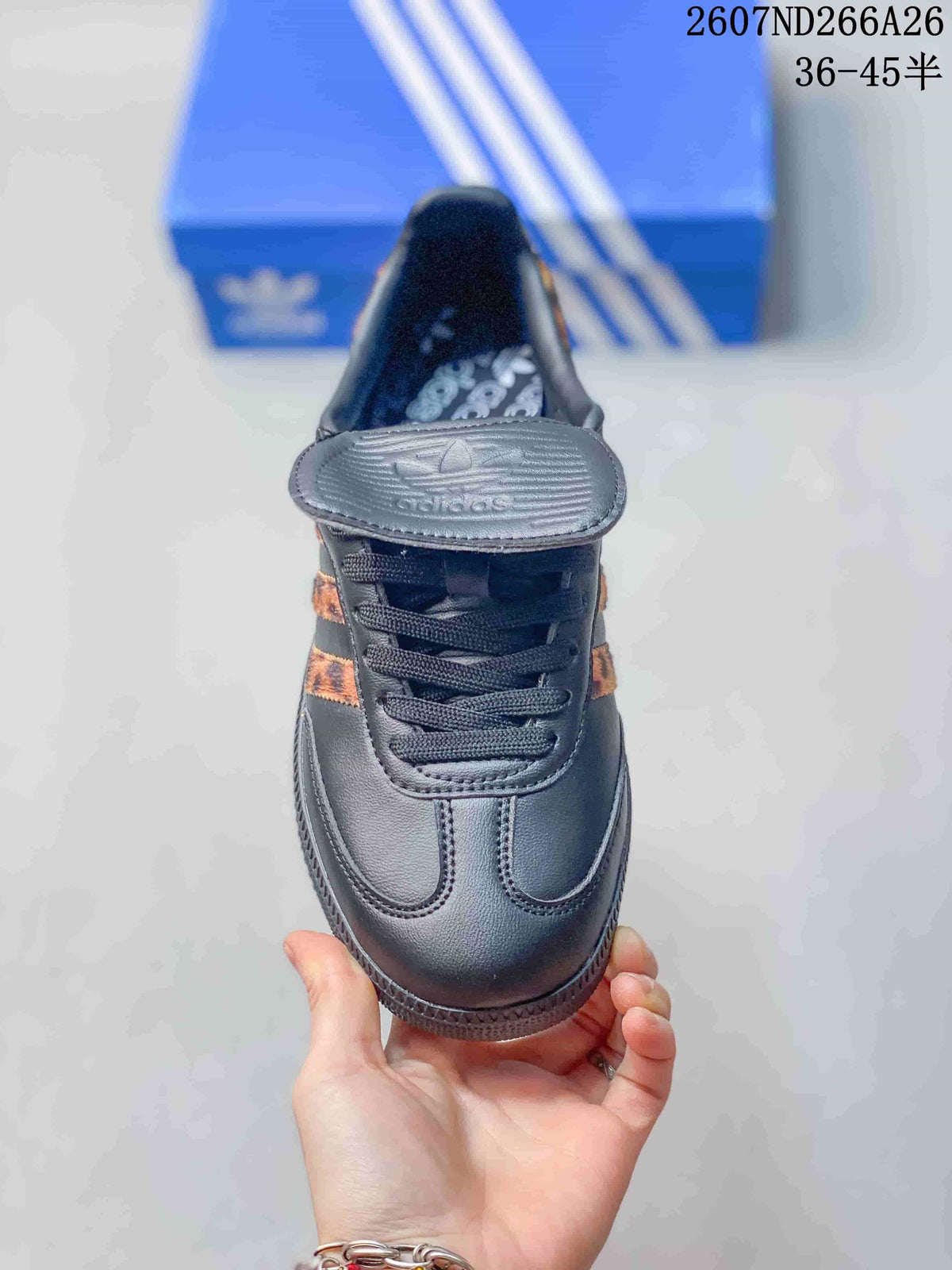 Front view showing the rounded black toe, black laces, and extended tongue with adidas branding.