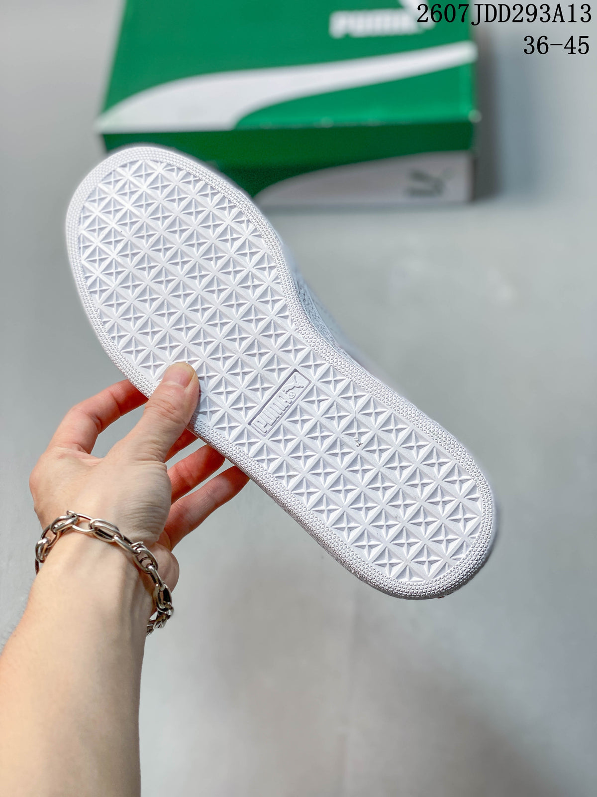 Close-up of the white rubber outsole showing a repeating geometric traction pattern and embossed PUMA branding.