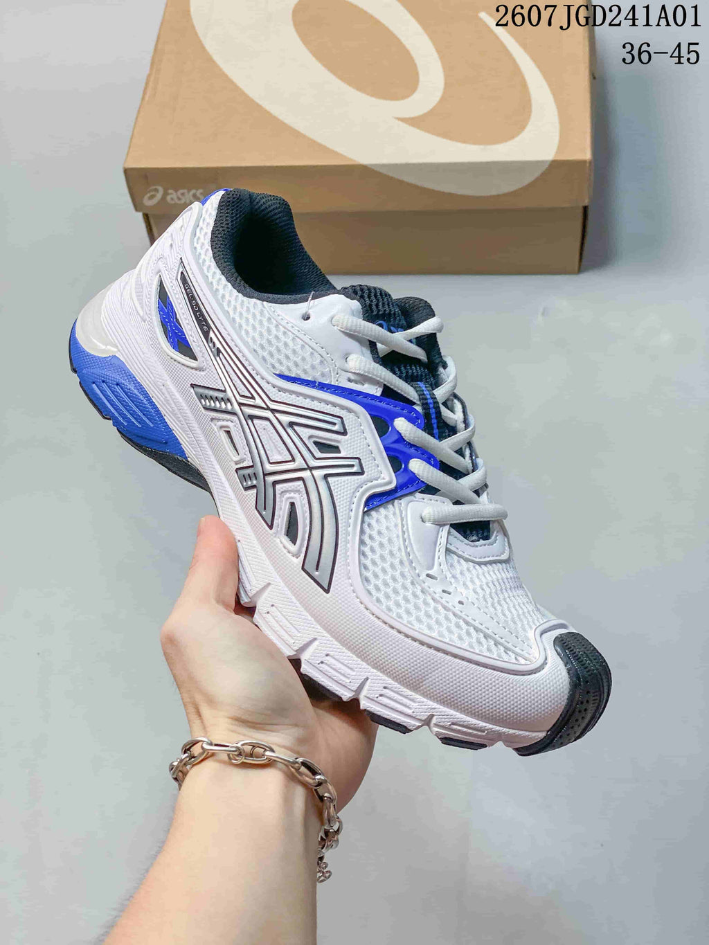 ASICS GEL-SD Lyte sneaker in white, blue and dark gray, shown with a shoebox.