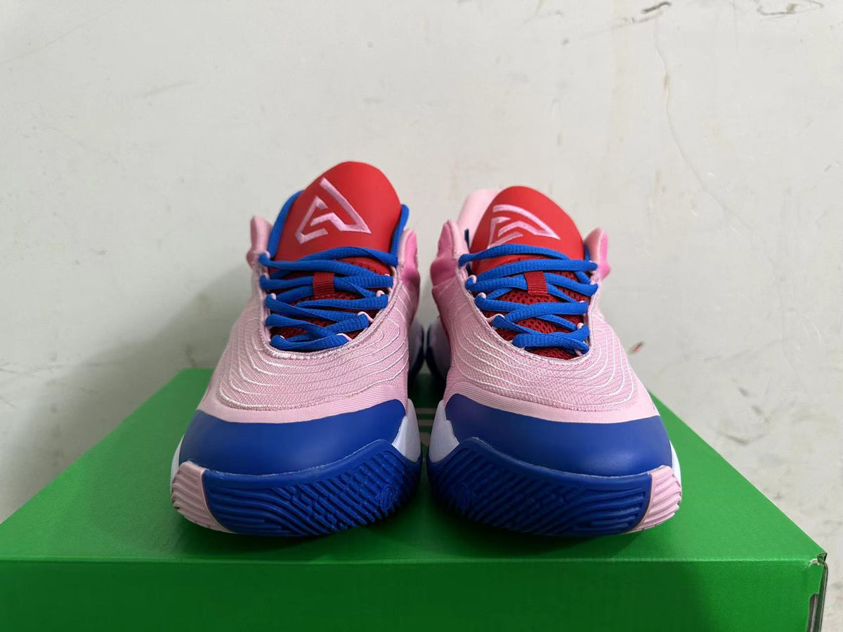 Front view showing pink Nike basketball shoes with blue laces, red tongues, and blue toe accents.