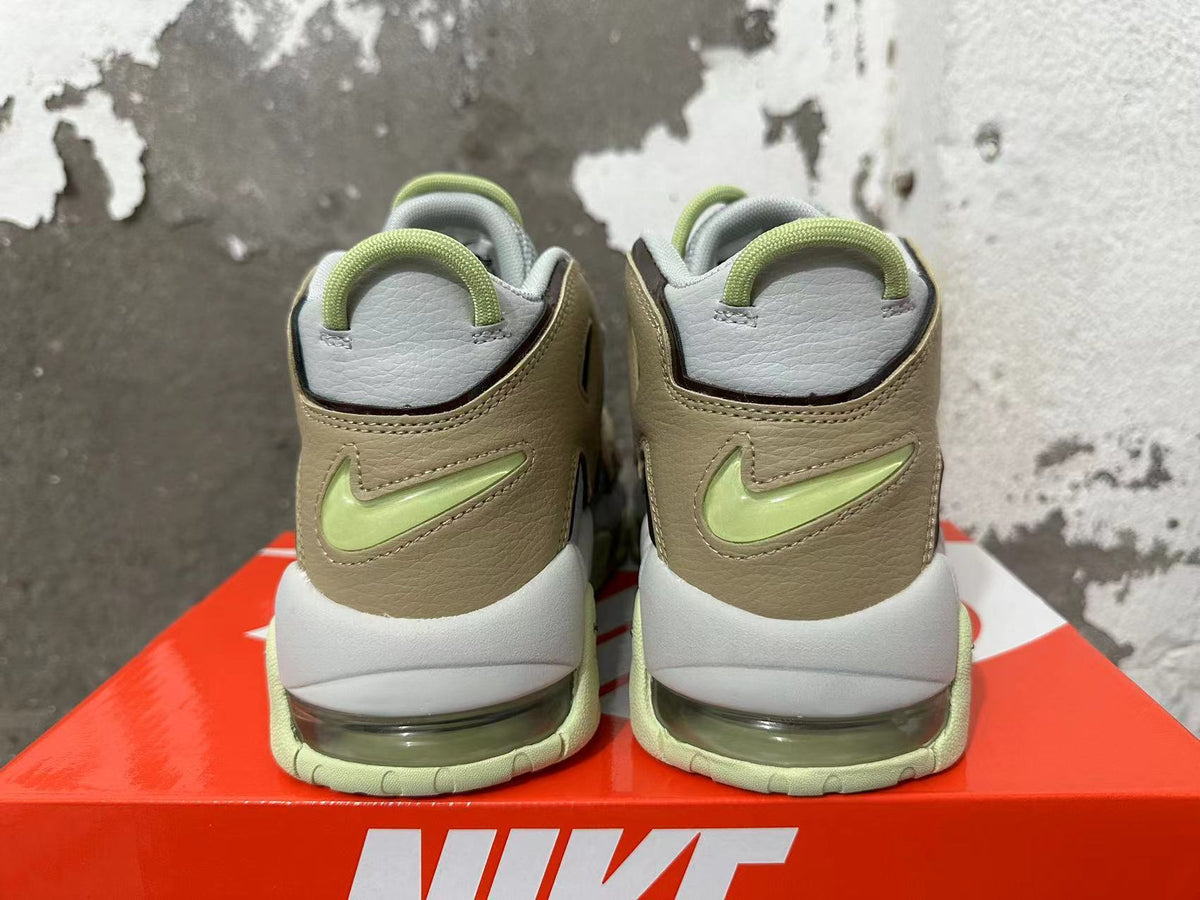 Rear view of gray and brown Nike sneakers with light lime accents and visible heel air units.