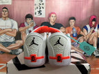 Rear view of white basketball shoes with black heel logos and red accents