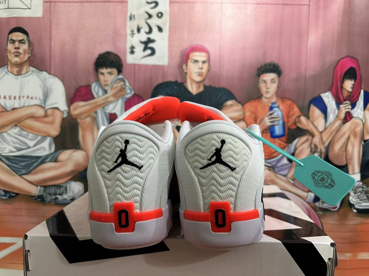 Rear view of white basketball shoes with black heel logos and red accents