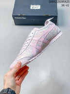 Side profile showing the pastel floral upper, pink stripes, and low-top silhouette.